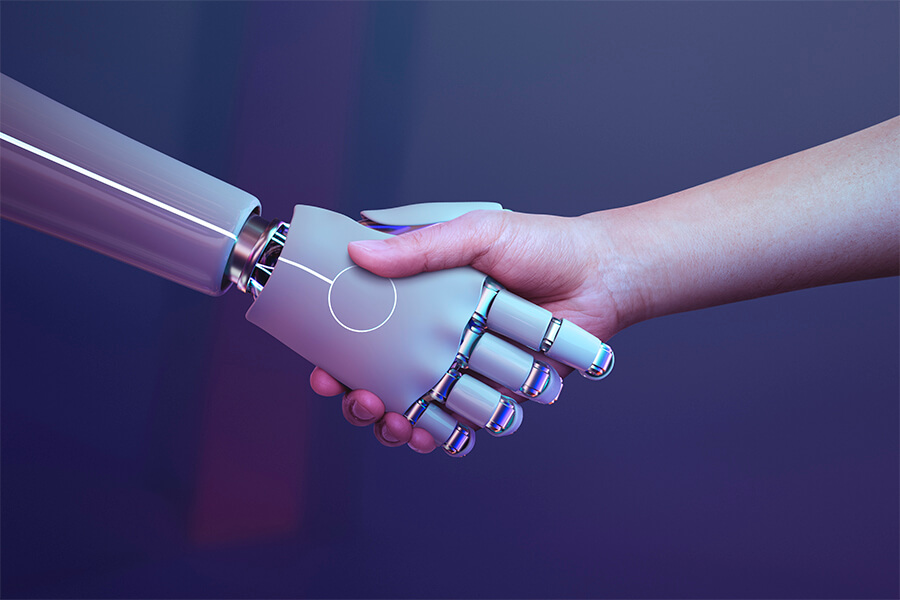 A robot and a human shaking hands symbolizing collaboration.